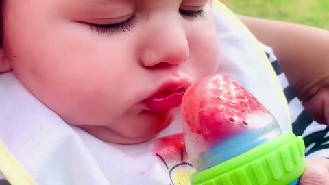 Baby first time eating a strawberry and do not want to let go of it