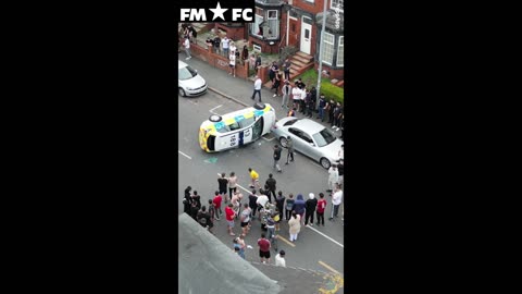 Shocking scenes in Leeds as gang of thugs overturns a police car