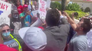 Alex Stein confronts protestors outside the Tampa Convention Center