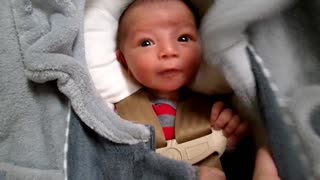 Adorable newborn baby makes silly faces