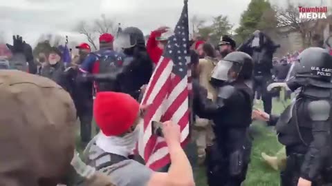 Jan. 6 Trump supporters are seen protecting the police from antifa.