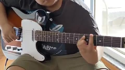 Kid playing Electric Guitar