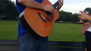 Playing music at the lake on a summer's Eve