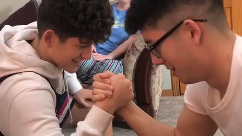 Arm wrestle between brothers