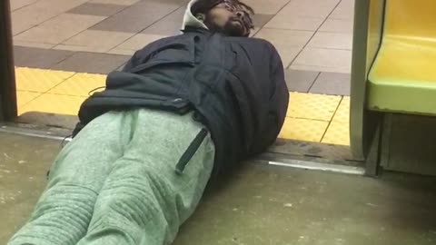 Man on floor crawls falls off subway