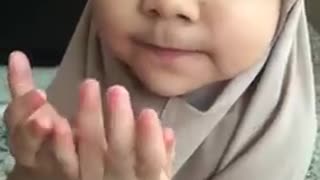 Cute Muslim Girl Recites Prayer With Her Mother.