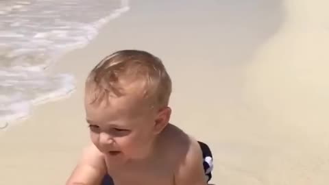 Cute baby reaction on beach