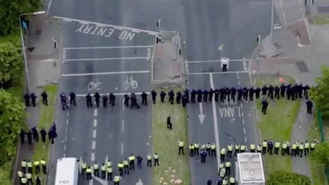 "Drone Footage: Irish Police Charge Locals Protesting Asylum Seekers' Center in Coolock"