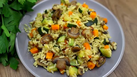 Rice with mushrooms and zucchini in a pan. A simple and delicious recipe.