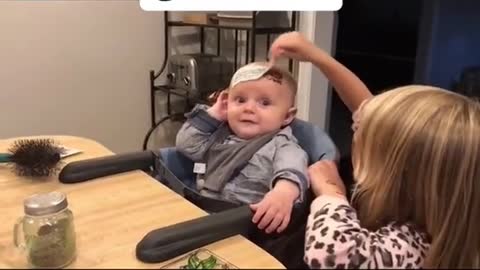 Parents Laugh As Little Girl Puts Temporary Tattoo On Her Brother's Forehead
