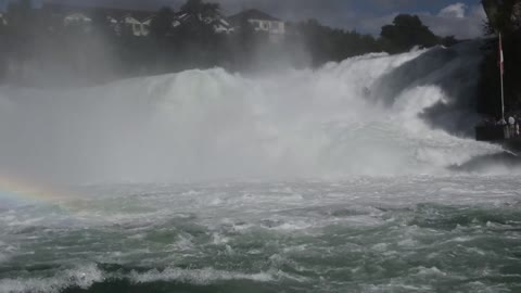 Tourist In The View Deck Looking At The Strong Force Of A River