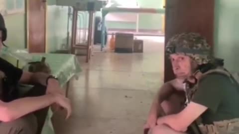 Ukrainian troops position themselves in a school and seem severely under equipped. Slippers?