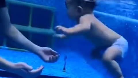 The child is swimming in the swimming pool
