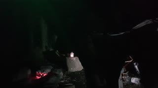 Embers in a firepit. Riverside wildcamping