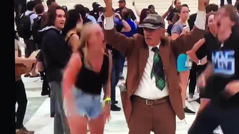 Young Woman Slaps Elderly Man's Sign