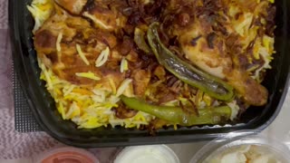 Kabsa rice with vegetables and chicken on a plate
