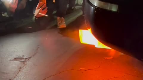 ohh wow, what's happening there, The car's exhaust is on fire.