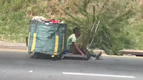 African boy races down highway in engine less cart- unbelievable!