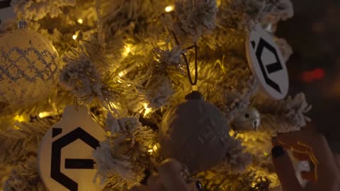 Decorating a Christmas tree with baubles