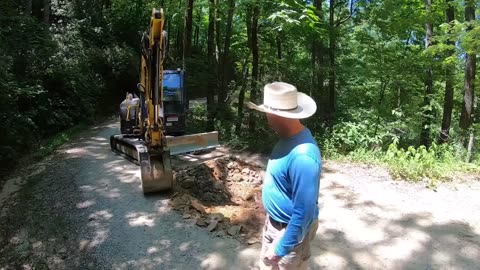 Yanmar Vio80 And Ford L9000 Dump Truck Working On Gravel Road