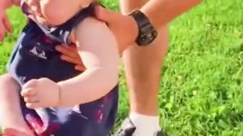 Funny baby playing with father