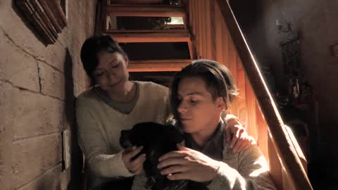 Young family hugging their dog,