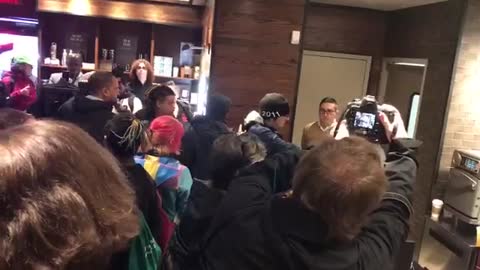 Protestors confront Starbucks corporate employees