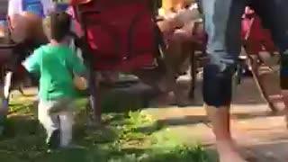 Little kid in green walking around pouring drinks for people sped up