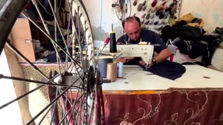 Bicycle pedal power keeps business afloat for Gaza tailor