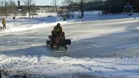 Guy films man using leaf blower on ice