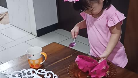 Pretty Baby eating dragon fruit