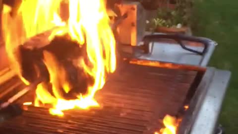 Women grilling in open flame, flame extends and woman screams