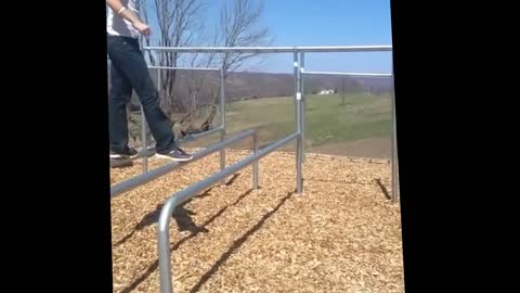 Guy playground bars jump bellyflop