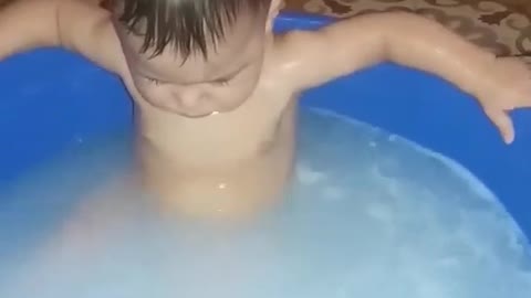 A young child enjoys bathing It's very funny