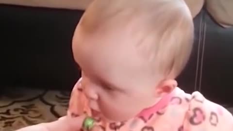 Baby girl tastes olives for the first time