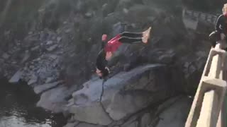 Dude jumps off bridge, performs epic cliff dive