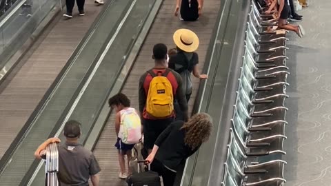 Travelers Have Fun on Moving Walkway at Denver Airport