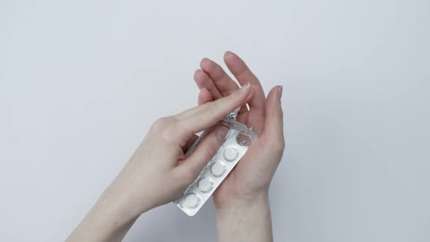 Taking Medicine From Its Packaging