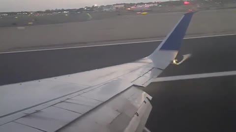 Wing tip scratches runway before touchdown