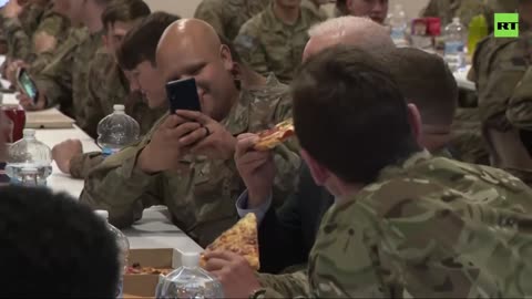 Biden eats pizza with US troops in Poland