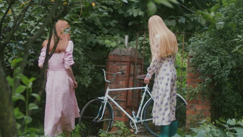 Women Walking while Looking at the Bicycle More info Share