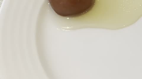 Brown golden Rose Jamun in sweet syrup wow scene