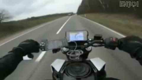 motorbiker rides in between other riders overtaking in opposite direction