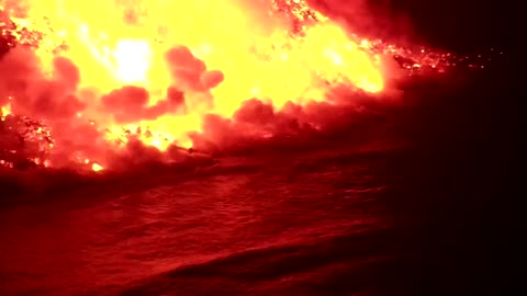 Watch the La Palma volcano flow into dark seas