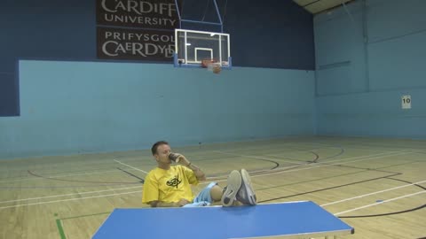 Guy Finger Spins Basketball Then Lands 3 Pointer Back Turned Sipping a Drink