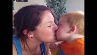 Baby pukes on mother as mom kisses her