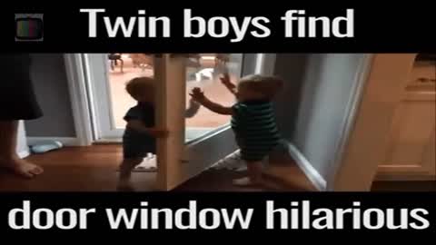 Twin boys find door window hilarious