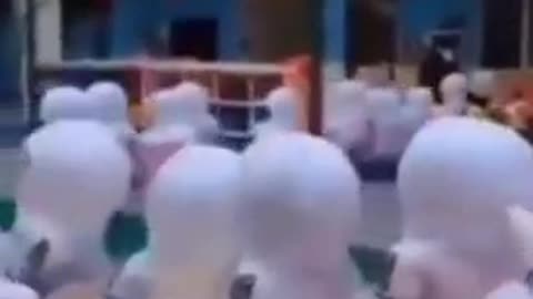 Children in China wearing full Hazmat suits in schools