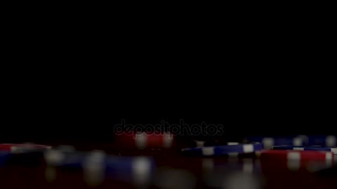 playing chips flying at the poker table on black background