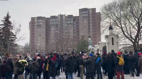 Mourners chant "Navalny, Navalny" outside the church in Moscow